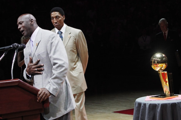 Michael Jordan, left, addresses the crowd as Scottie Pippen listen, during a 20th anniversary celebration of the Bulls' 1990-91 NBA championship season, their first, during halftime of an NBA game against the Bulls and Utah Jazz  Saturday, March 12, 2011, in Chicago. (AP Photo/Charles Rex Arbogast)