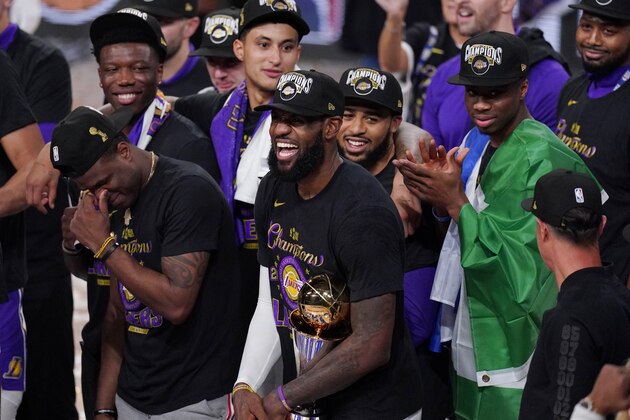 Los Angeles Lakers' LeBron James (23) celebrates with his teammates after the Lakers defeated the Miami Heat 106-93 in Game 6 of basketball's NBA Finals Sunday, Oct. 11, 2020, in Lake Buena Vista, Fla. (AP Photo/Mark J. Terrill)