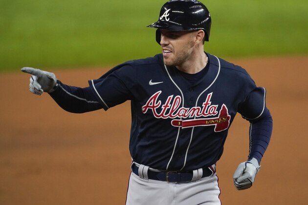 Atlanta Braves' Freddie Freeman points after a home run during the first inning in Game 1 of a baseball National League Championship Series against the Los Angeles Dodgers Monday, Oct. 12, 2020, in Arlington, Texas.(AP Photo/Tony Gutierrez) Atlanta Braves' Freddie Freeman points after a home run during the first inning in Game 1 of a baseball National League Championship Series against the Los Angeles Dodgers Monday, Oct. 12, 2020, in Arlington, Texas.(AP Photo/Tony Gutierrez)