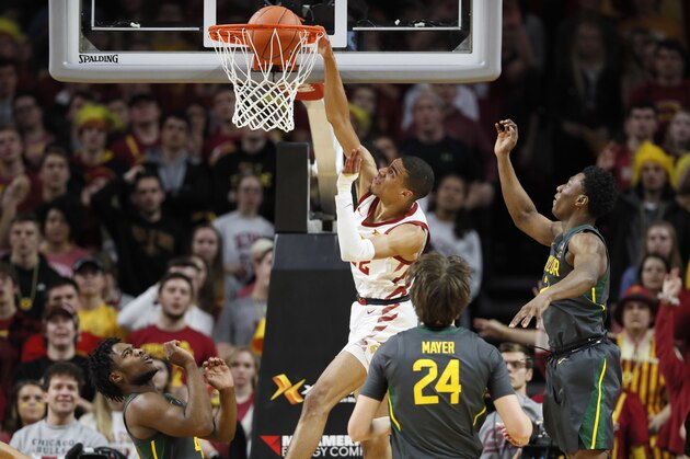 Iowa State guard Tyrese Haliburton dunks next to Baylor guard Devonte Bandoo, right, during the first half of an NCAA college basketball game Wednesday, Jan. 29, 2020, in Ames, Iowa. (AP Photo/Charlie Neibergall)