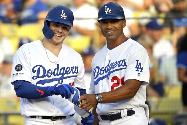 Los Angeles Dodgers' Gavin Lux, left, smiles as he stands with first base coach George Lombard after hitting a single during the second inning of a baseball game Monday, Sept. 2, 2019, in Los Angeles. (AP Photo/Mark J. Terrill)