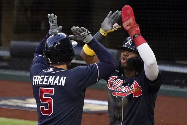 Atlanta Braves' Freddie Freeman celebrates his two-run home run with Ronald Acuna Jr. during the fourth inning in Game 2 of a baseball National League Championship Series Tuesday, Oct. 13, 2020, in Arlington, Texas. (AP Photo/Tony Gutierrez)