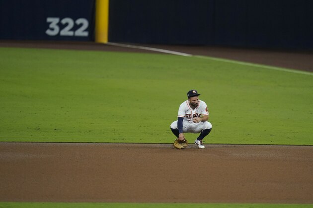 Houston Astros second baseman Jose Altuve reacts after a missed throw to second during the sixth inning in Game 3 of a baseball American League Championship Series against the Tampa Bay Rays, Tuesday, Oct. 13, 2020, in San Diego. (AP Photo/Gregory Bull)