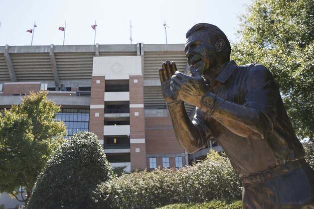 Nick Saban's statue stands among fewer fans than normal as Alabama, playing against Texas A&M, and its fans adjust to the new 'Covid normal' on NCAA college football game day, Saturday, Oct. 3, 2020, in Tuscaloosa, Ala. A restricted number of fans were allowed to attend the game, meaning many did not travel to the city, while others sought social opportunities at restaurants and bars. (AP Photo/Vasha Hunt)