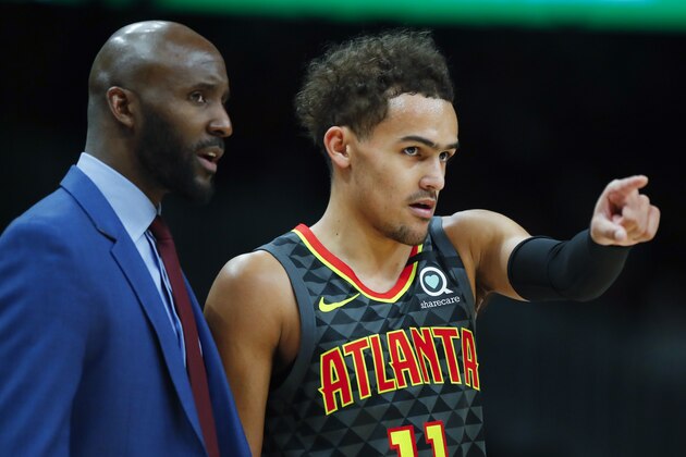 Atlanta Hawks guard Trae Young (11) reacts with head coach Lloyd Pierce in the first half of an NBA basketball game against the New York Knicks on Sunday, Feb. 9, 2020, in Atlanta. (AP Photo/Todd Kirkland)