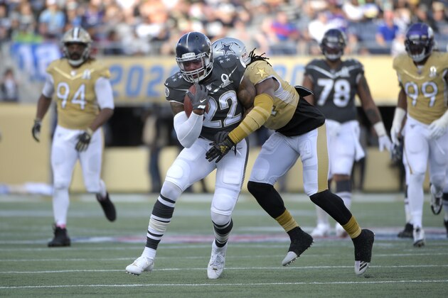 NFC inside linebacker Jaylon Smith (54), of the Dallas Cowboys, stops AFC running back Derrick Henry (22), of the Tennessee Titans, after running for yardage during the second half of the NFL Pro Bowl football game Sunday, Jan. 26, 2020 in Orlando, Fla. (AP Photo/Phelan M. Ebenhack)