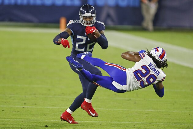 Tennessee Titans running back Derrick Henry (22) knocks down Buffalo Bills cornerback Josh Norman (29) in the first half of an NFL football game Tuesday, Oct. 13, 2020, in Nashville, Tenn. (AP Photo/Wade Payne)