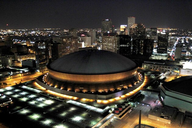In this July 31, 2010 photo, the Louisiana Superdome and New Orleans skyline are seen from the air at night. Once considered the Cadillac of sports stadiums, the venerable Louisiana Superdome will become the Mercedes-Benz Superdome under a naming rights deal to be formally announced on Tuesday. The New Orleans Saints, who hold authority under an agreement with the state to sell naming rights to the Dome, confirmed an agreement with Mercedes-Benz had been reached. (AP Photo/Gerald Herbert)