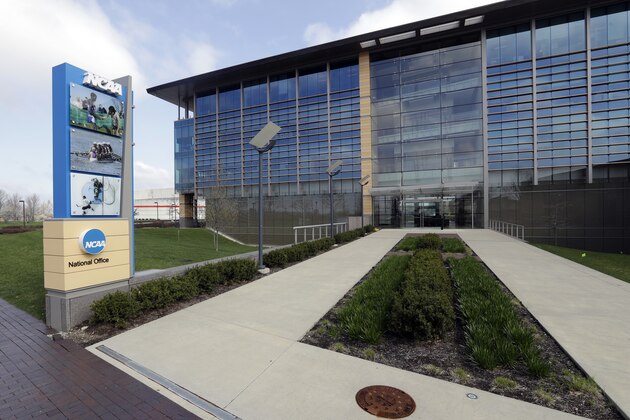 FILE - This is an April 25, 2018, file photo showing NCAA headquarters in Indianapolis. The NCAA has adjusted some of the guidelines used to determine transfer waiver cases, attempting to clarify requirements in response to complaints of ambiguity in the process of requesting immediate eligibility for an athlete switching schools. The adjustments approved by the Division I council Wednesday, June 26, 2019, will require schools requesting a waiver for an incoming transfer to provide more documentation to support a case and more detailed verification of an athlete’s claims from the original school. (AP Photo/Darron Cummings, File)