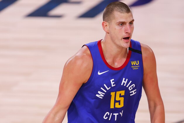 Denver Nuggets' Nikola Jokic moves the ball against the Utah Jazz during the first quarter of Game 3 of an NBA basketball first-round playoff series, Friday, Aug. 21, 2020, in Lake Buena Vista, Fla. (Mike Ehrmann/Pool Photo via AP)