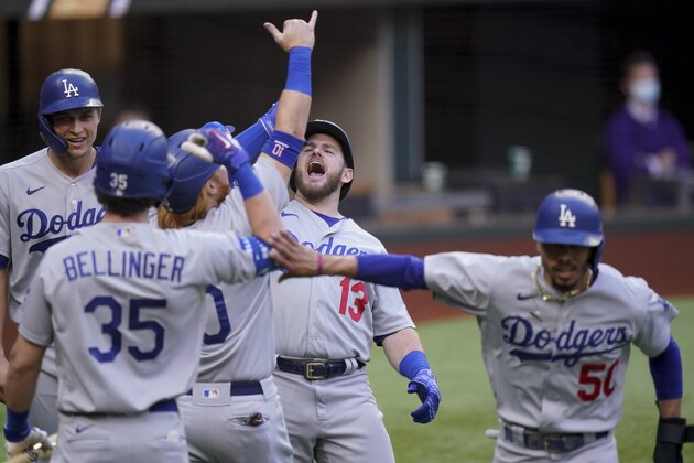 Los Angeles Dodgers' Max Muncy (13) celebrates his grand slam home run during the first inning in Game 3 of a baseball National League Championship Series against the Atlanta Braves Wednesday, Oct. 14, 2020, in Arlington, Texas. (AP Photo/Eric Gay)