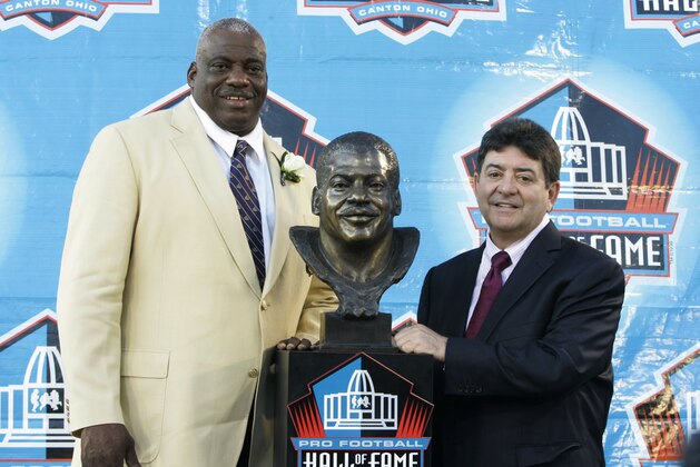 Former San Diego Chargers defensive end Fred Dean stands next to his bronze bust with former San Francisco 49ers owner Eddie DeBartolo at the Pro Football Hall of Fame on Saturday, Aug. 2, 2008. in Canton, Ohio.  (AP Photo/Kiichiro Sato)