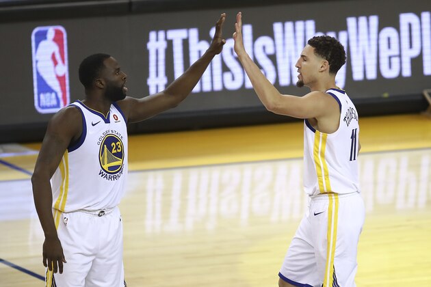 Golden State Warriors forward Draymond Green (23) celebrates with guard Klay Thompson during the second half of Game 6 of the NBA basketball Western Conference Finals against the Houston Rockets in Oakland, Calif., Saturday, May 26, 2018. (AP Photo/Ben Margot)