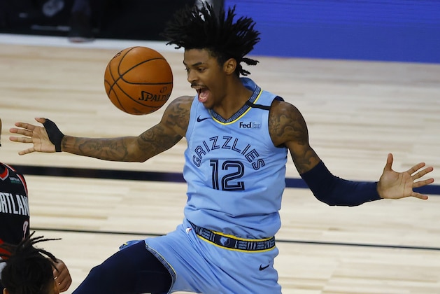 Memphis Grizzlies' Ja Morant reacts after a dunk against the Portland Trail Blazers during the second half of an NBA basketball game Saturday, Aug. 15, 2020, in Lake Buena Vista, Fla. (Kevin C. Cox/Pool Photo via AP)