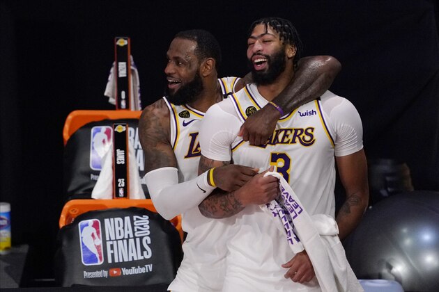 Los Angeles Lakers' LeBron James (23) and Anthony Davis (3) celebrate after the Lakers defeated the Miami Heat 106-93 in Game 6 of basketball's NBA Finals Sunday, Oct. 11, 2020, in Lake Buena Vista, Fla. (AP Photo/Mark J. Terrill)