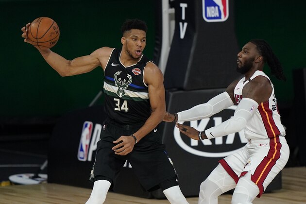 Milwaukee Bucks' Giannis Antetokounmpo (34) looks to pass around Miami Heat's Jae Crowder (99), right, during the first half an NBA conference semifinal playoff basketball game Wednesday, Sept. 2, 2020, in Lake Buena Vista, Fla. (AP Photo/Mark J. Terrill)