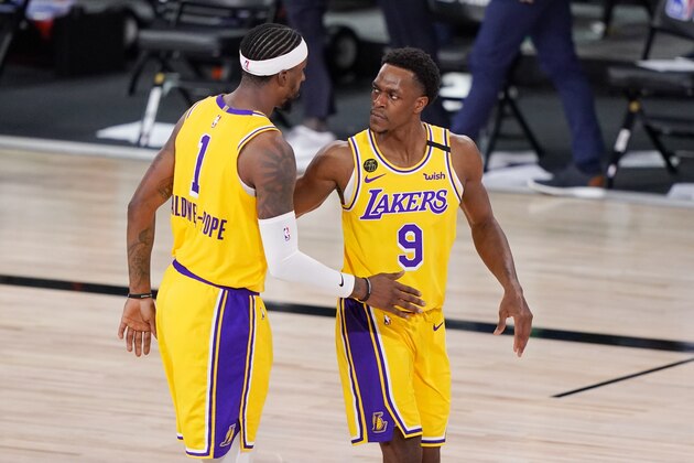 Los Angeles Lakers' Kentavious Caldwell-Pope (1) and Rajon Rondo (9) congratulate one another after beating the Denver Nuggets 114-108 in an NBA conference final playoff basketball game Thursday, Sept. 24, 2020, in Lake Buena Vista, Fla. (AP Photo/Mark J. Terrill)