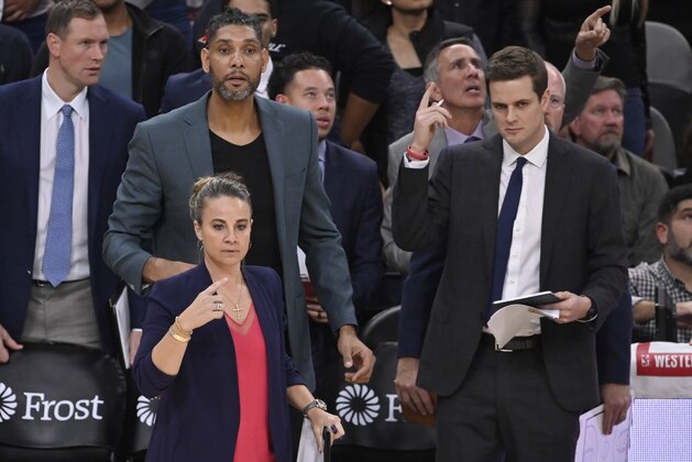 San Antonio Spurs assistant coach Becky Hammon, front left, and acting head coach Tim Duncan, behind her, signal to players during the second half of an NBA basketball game against the Portland Trail Blazers, as assistant coach Will Hardy stands by at right, Saturday, Nov. 16, 2019, in San Antonio. Portland won 121-116. Duncan became acting head coach after Spurs head coach Gregg Popovich was ejected after being called for two technical fouls. (AP Photo/Darren Abate)