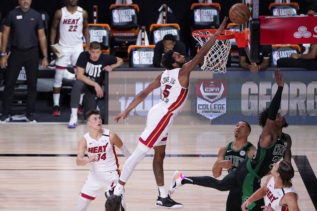 Miami Heat forward Derrick Jones Jr. (5) attempts to block a shot attempt by Boston Celtics guard Marcus Smart, top right, during the second half of an NBA conference final playoff basketball game, Thursday, Sept. 17, 2020, in Lake Buena Vista, Fla. The Heat's Tyler Herro (14) Kelly Olynyk, bottom right, and the Celtics' Grant Williams, right rear, look on at the play. (AP Photo/Mark J. Terrill)
