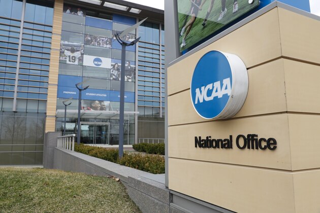 Final Four flag fly over the headquarter of the NCAA in Indianapolis, Thursday, March 12, 2020. (AP Photo/Michael Conroy)