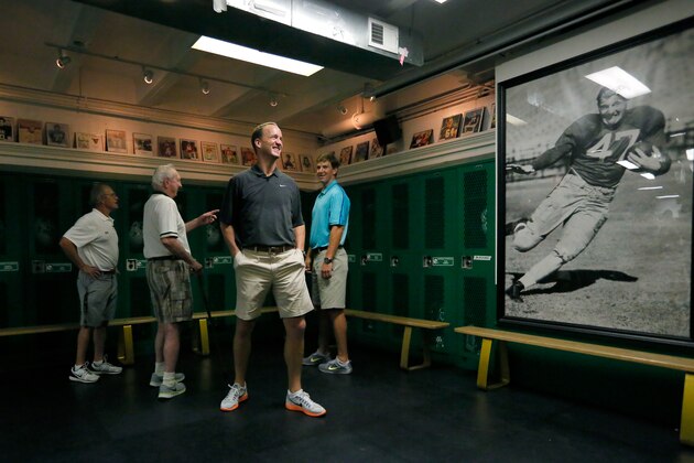 IMAGE DISTRIBUTED FOR NATIONAL FOOTBALL LEAGUE - In this photo released by the NFL, Denver Broncos quarterback Peyton Manning and New York Giants quarterback Eli Manning visit Isidore Newman School in New Orleans on Thursday, July 9, 2015. (Jonathan Bachman/AP Images for National Football League)