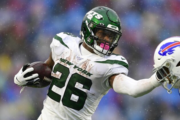 New York Jets running back Le'Veon Bell (26) stiff-arms Buffalo Bills' Jaquan Johnson (46) during the first half of an NFL football game Sunday, Dec. 29, 2019 in Orchard Park, N.Y. (AP Photo/David Dermer)