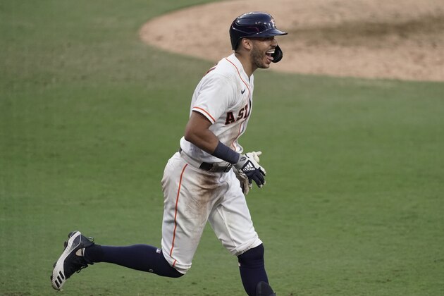Houston Astros Carlos Correa reacts after his walk off home run during the ninth inning in Game 5 of a baseball American League Championship Series, Tuesday, Dec. 15, 2020, in San Diego. The Astros defeated the Rays 4-3 and the Rays lead the series 3-2 games. (AP Photo/Ashley Landis)
