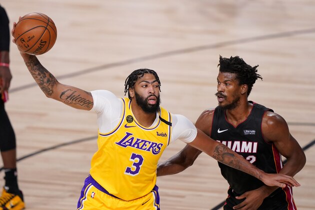 Los Angeles Lakers forward Anthony Davis passes around Miami Heat forward Jimmy Butler during the first half in Game 4 of basketball's NBA Finals Tuesday, Oct. 6, 2020, in Lake Buena Vista, Fla. (AP Photo/Mark J. Terrill)