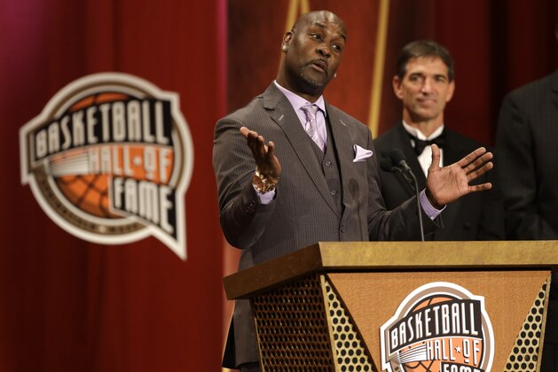 Inductee Gary Payton, left, speaks during the enshrinement ceremony for the 2013 class of the Naismith Memorial Basketball Hall of Fame as Hall of Famer John Stockton, right, looks on at Symphony Hall in Springfield, Mass., Sunday, Sept. 8, 2013. (AP Photo/Steven Senne)