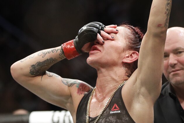 Cris Cyborg celebrates after defeating Holly Holm during a featherweight championship mixed martial arts bout at UFC 219, Saturday, Dec. 30, 2017, in Las Vegas. (AP Photo/John Locher)