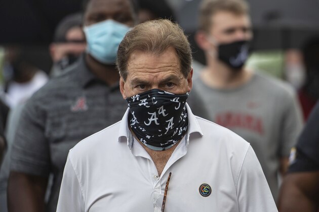 FILE - In this Aug. 31, 2020, file photo, Alabama head football coach Nick Saban leads his team as they march on campus, supporting the Black Lives Matter movement, in Tuscaloosa, Ala. The mid-week news that Alabama coach Nick Saban tested positive for COVID-19 added a challenging backdrop for the seasonâ€™s first Top 5 matchup. Saban figures to be communicating his marching orders and input from home while offensive coordinator Steve Sarkisian is manning the show within the football building. (AP Photo/Vasha Hunt, File)