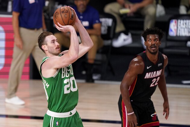 Boston Celtics forward Gordon Hayward (20) takes a shot as Miami Heat's Jimmy Butler (22) looks on during the second half of Game 4 of an NBA basketball Eastern Conference final, Wednesday, Sept. 23, 2020, in Lake Buena Vista, Fla. (AP Photo/Mark J. Terrill)