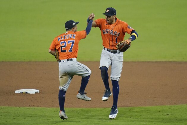 Houston Astros Carlos Correa (1) celebrates with Jose Altuve after winning Game 6 of a baseball American League Championship Series, Friday, Oct. 16, 2020, in San Diego. The Astros defeated the Rays 7-4 to tie the series 3-3. (AP Photo/Gregory Bull)
