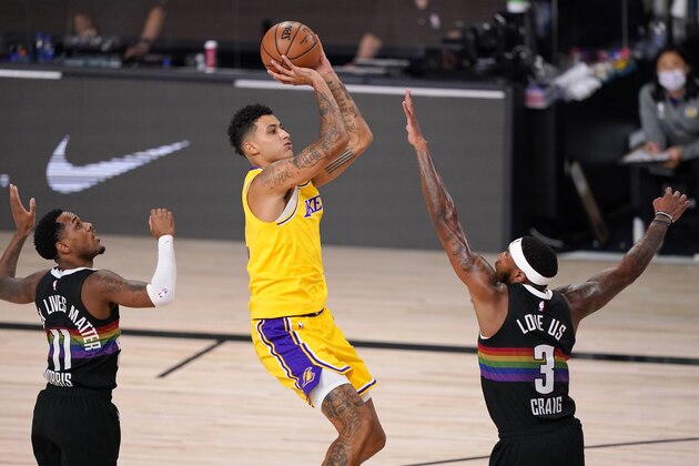 Los Angeles Lakers' Kyle Kuzma, center, shoots against Denver Nuggets' Monte Morris (11) and Torrey Craig (3) during the first half of an NBA conference final playoff basketball game Thursday, Sept. 24, 2020, in Lake Buena Vista, Fla. (AP Photo/Mark J. Terrill)