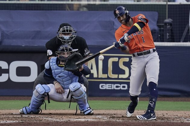 Houston Astros Carlos Correa hits an RBI single during the fifth inning in Game 6 of a baseball American League Championship Series against the Tampa Bay Rays, Friday, Oct. 16, 2020, in San Diego. (AP Photo/Jae C. Hong)