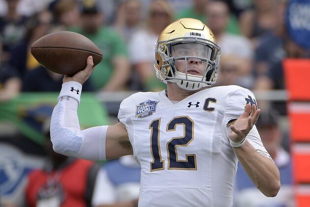 Notre Dame quarterback Ian Book (12) throws a pass during the first half of the Camping World Bowl NCAA college football game against Iowa State Saturday, Dec. 28, 2019, in Orlando, Fla. (AP Photo/Phelan M. Ebenhack)