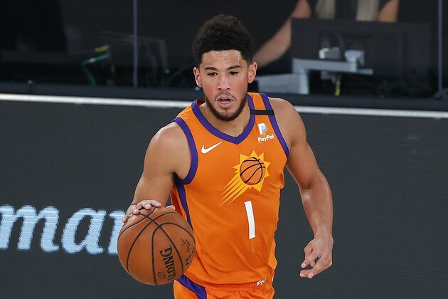 Phoenix Suns' Devin Booker dribbles the ball down court against the Indiana Pacers during the first half of an NBA basketball game Thursday, Aug. 6, 2020, in Lake Buena Vista, Fla. (Kevin C. Cox/Pool Photo via AP)