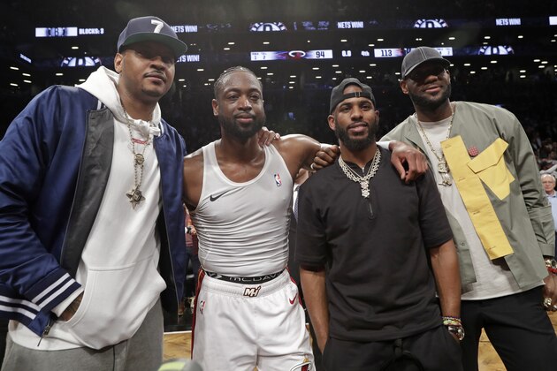 Carmelo Anthony, Miami Heat guard Dwyane Wade, Houston Rockets guard Chris Paul and Los Angeles Lakers forward LeBron James. from left, pose for a photographs on the court after Wade's final NBA basketball game, against the Brooklyn Nets on Wednesday, April 10, 2019, in New York. (AP Photo/Kathy Willens)