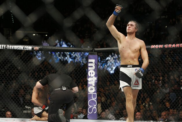 Brian Ortega, right, celebrates after defeating Diego Brandao during a featherweight mixed martial arts bout at UFC 195, Saturday, Jan. 2, 2016, in Las Vegas. (AP Photo/John Locher)