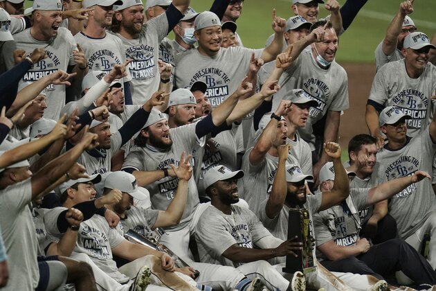 Tampa Bay Rays pose with the American League championship trophy following their victory against the Houston Astros in Game 7 of a baseball American League Championship Series, Saturday, Oct. 17, 2020, in San Diego. The Rays defeated the Astros 4-2 to win the series 4-3 games. (AP Photo/Gregory Bull) Tampa Bay Rays pose with the American League championship trophy following their victory against the Houston Astros in Game 7 of a baseball American League Championship Series, Saturday, Oct. 17, 2020, in San Diego. The Rays defeated the Astros 4-2 to win the series 4-3 games. (AP Photo/Gregory Bull)
