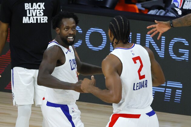 Los Angeles Clippers' Patrick Beverley celebrates with Kawhi Leonard, right, during the team's NBA basketball game against the New Orleans Pelicans on Saturday, Aug. 1, 2020, in Lake Buena Vista, Fla. (Kevin C. Cox/Pool Photo via AP)