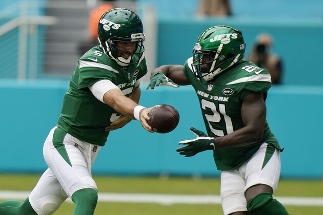 New York Jets quarterback Joe Flacco (5) hands the ball to running back Frank Gore (21), during the first half of an NFL football game against the Miami Dolphins Sunday, Oct. 18, 2020, in Miami Gardens, Fla. (AP Photo/Lynne Sladky)
