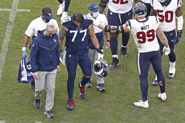 Houston Texans defensive end J.J. Watt (99) reaches out to Tennessee Titans offensive tackle Taylor Lewan (77) after Lewan was injured in the second half of an NFL football game Sunday, Oct. 18, 2020, in Nashville, Tenn. (AP Photo/Wade Payne) Houston Texans defensive end J.J. Watt (99) reaches out to Tennessee Titans offensive tackle Taylor Lewan (77) after Lewan was injured in the second half of an NFL football game Sunday, Oct. 18, 2020, in Nashville, Tenn. (AP Photo/Wade Payne)