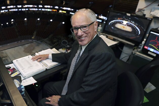 In this Wednesday, May 29, 2019, photo, NBC hockey broadcaster Mike Emrick poses for a photo while preparing to call Game 2 of the NHL hockey Stanley Cup Final between the St. Louis Blues and the Boston Bruins in Boston. At 72, still calling games on the NHL’s biggest stage, Emrick is in his prime and showing no signs of slowing down and stepping away from broadcasting the fastest game on ice. “I really wanted to do it from the time I saw my first game, but a lot of people really want to do something and they don't get to,” Emrick said. “When you have a job like that, you're never working the rest of your life. So it's been 46 years. I don't know when it'll end. God only knows.” (AP Photo/Charles Krupa)