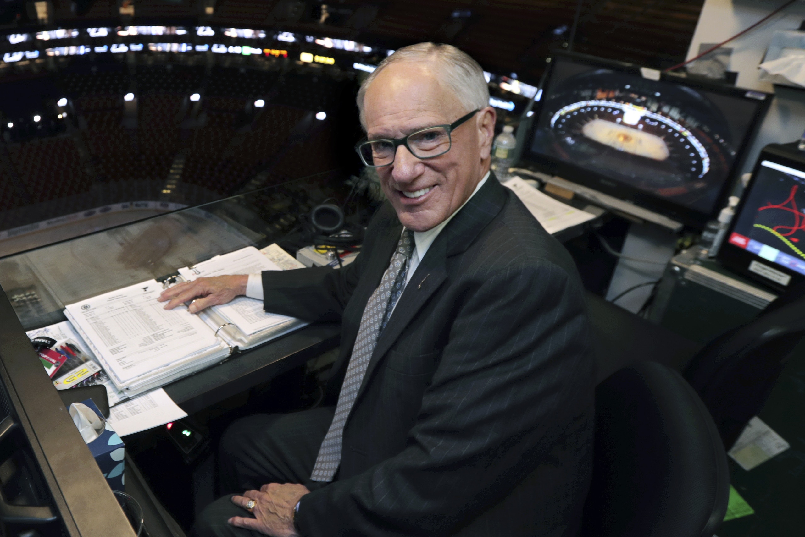 In this Wednesday, May 29, 2019, photo, NBC hockey broadcaster Mike Emrick poses for a photo while preparing to call Game 2 of the NHL hockey Stanley Cup Final between the St. Louis Blues and the Boston Bruins in Boston. At 72, still calling games on the NHL’s biggest stage, Emrick is in his prime and showing no signs of slowing down and stepping away from broadcasting the fastest game on ice. “I really wanted to do it from the time I saw my first game, but a lot of people really want to do something and they don't get to,” Emrick said. “When you have a job like that, you're never working the rest of your life. So it's been 46 years. I don't know when it'll end. God only knows.” (AP Photo/Charles Krupa)