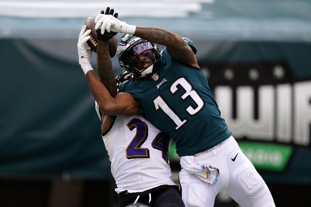 Philadelphia Eagles' Travis Fulgham (13) cannot catch a pass against Baltimore Ravens' Marcus Peters (24) during the second half of an NFL football game, Sunday, Oct. 18, 2020, in Philadelphia. (AP Photo/Chris Szagola)