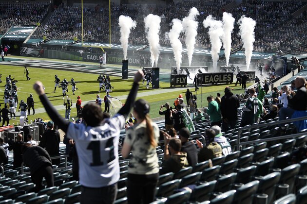 Fans cheer as the Philadelphia Eagles run onto the field before an NFL football game against the Baltimore Ravens, Sunday, Oct. 18, 2020, in Philadelphia. (AP Photo/Derik Hamilton)