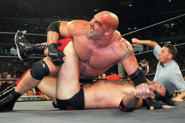 FILE - In this July 6, 1998, file photo, World Championship Wrestling heavyweight champion Bill Goldberg puts Scott Hall to the mat during a match in Atlanta. Bill Goldberg found his toughest tag-team partner yet.