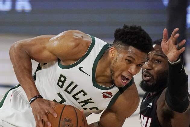 Milwaukee Bucks' Giannis Antetokounmpo, left, drives against Miami Heat's Jae Crowder, right, in the second half of an NBA conference semifinal playoff basketball game Friday, Sept. 4, 2020, in Lake Buena Vista, Fla. (AP Photo/Mark J. Terrill)