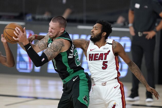 Boston Celtics' Daniel Theis, left, and Miami Heat's Derrick Jones Jr. (5) compete for a loose ball during the first half of an NBA conference final playoff basketball game, Tuesday, Sept. 15, 2020, in Lake Buena Vista, Fla. (AP Photo/Mark J. Terrill)